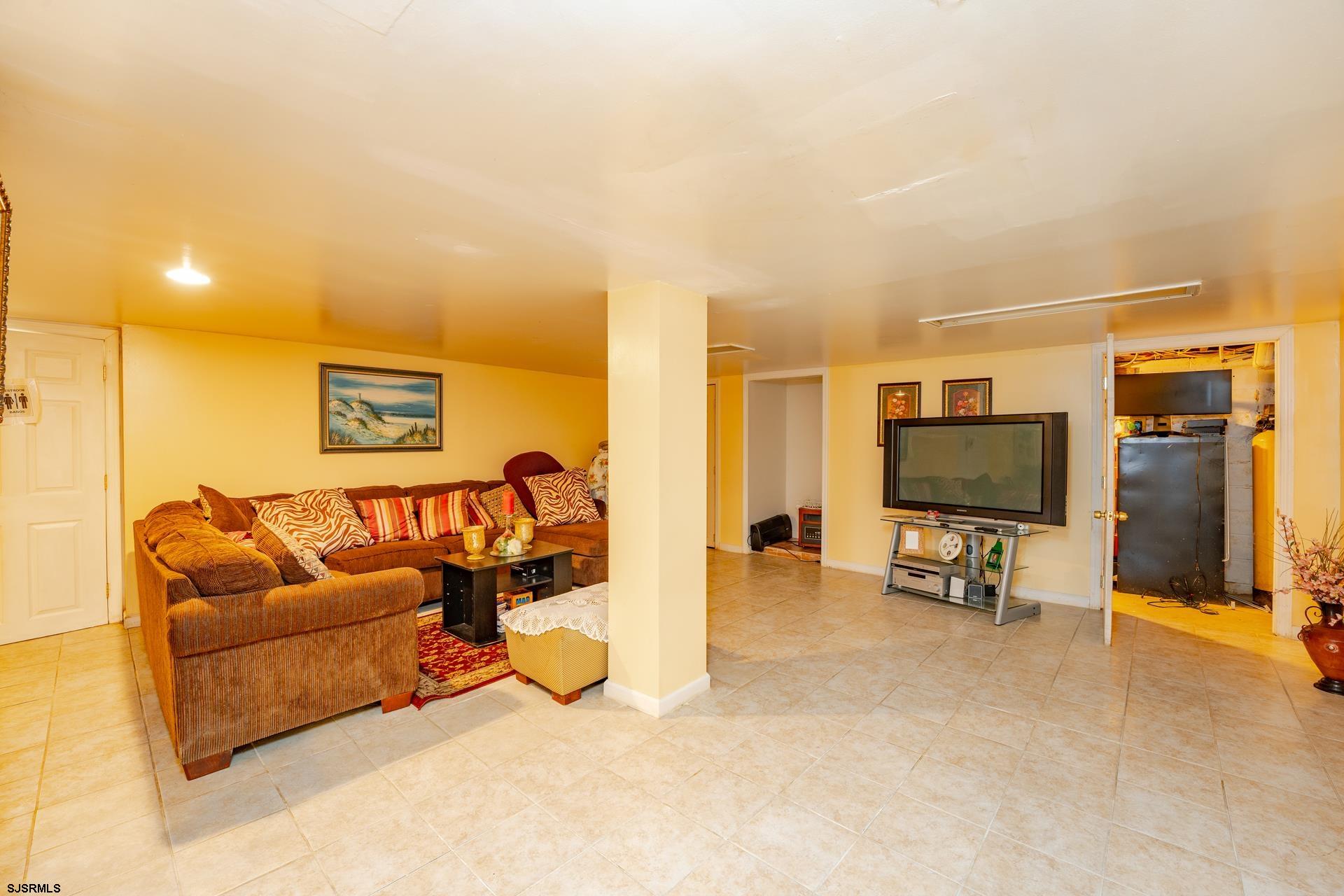 6529 Delilah Road Egg Harbor Township, NJ 08234 - Photo 33 of 70 a living room with furniture and a flat screen tv