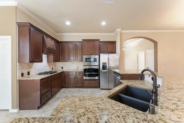 a view of an empty room with a fireplace and a window