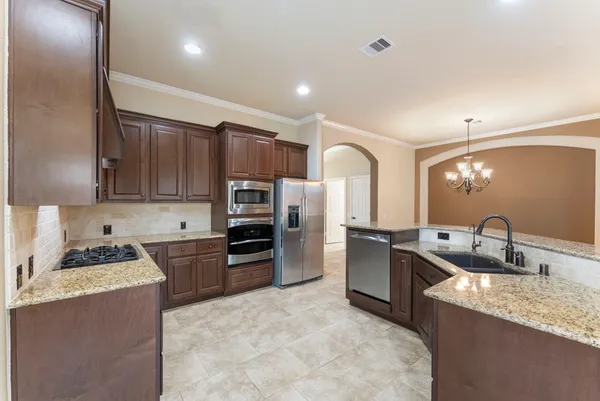 a view of a chandelier in big room and chandelier