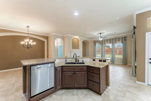 a view of a big room with a chandelier fan and closet area