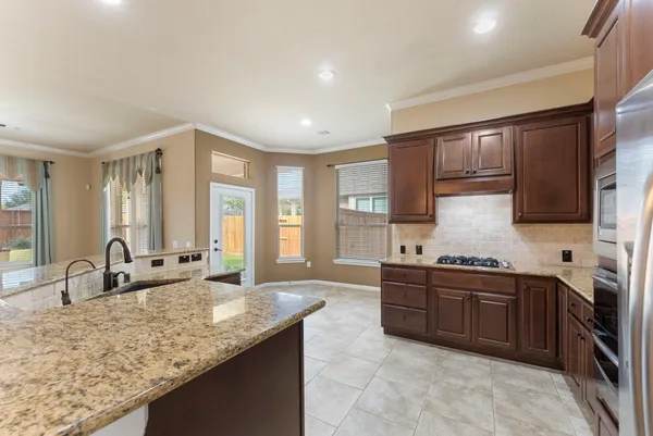 a spacious bathroom with a granite countertop sink and a mirror