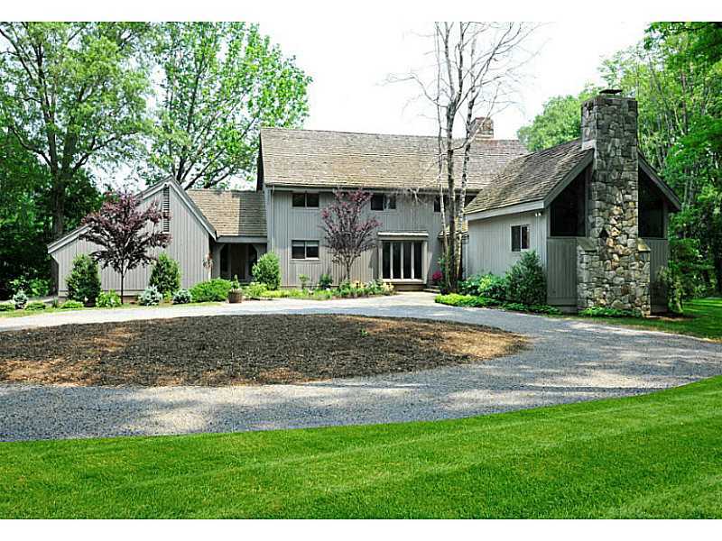 407 Round Hill Road Greenwich, CT 06831 - Photo 3 of 21 a front view of a house with a yard