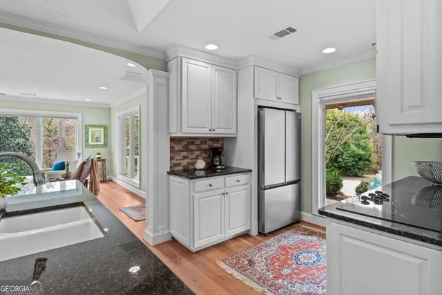a kitchen with stainless steel appliances a stove microwave and cabinets