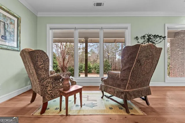 a view of a living room and dining room with wooden floor