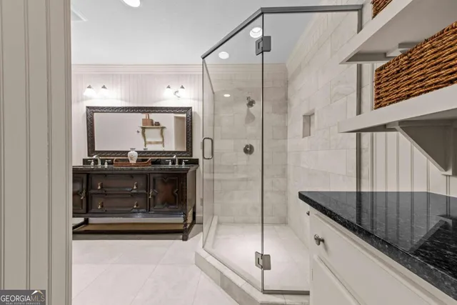 a bath room with a sink and mirror