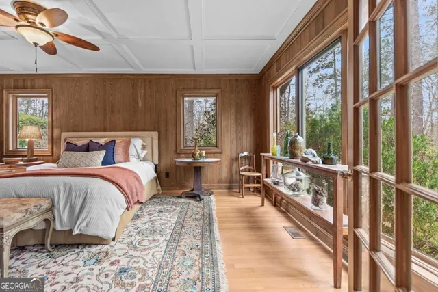 a view of a livingroom with furniture and a book shelf