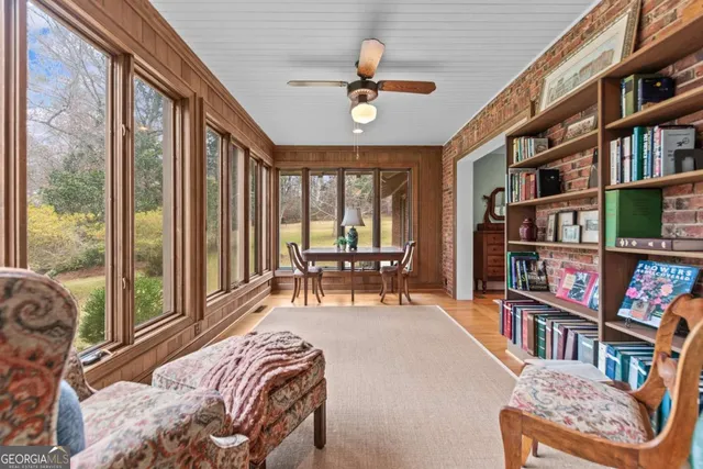 a living room with furniture and a book shelf