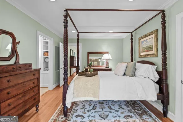 a bedroom with bed and a potted plant