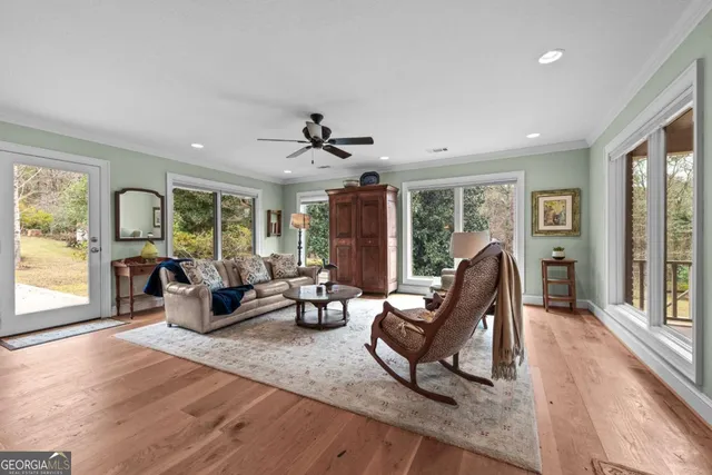 a living room with furniture and floor to ceiling windows