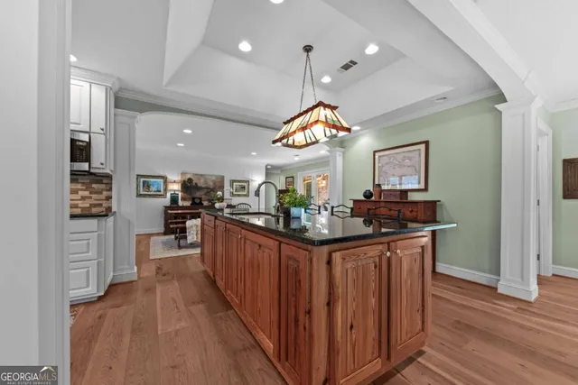 a living room with furniture dining table and a potted plant