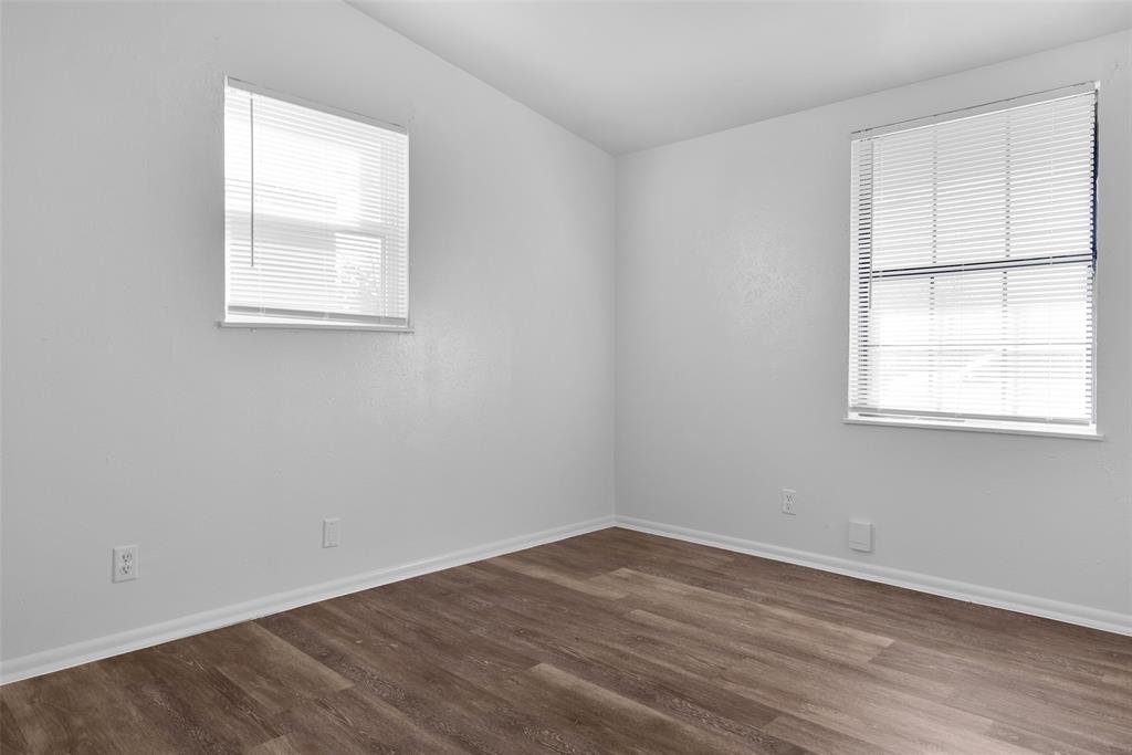 515 Forrest Lane Denison, TX 75021 - Photo 13 of 15 an empty room with wooden floor and windows