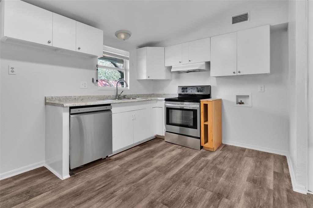 515 Forrest Lane Denison, TX 75021 - Photo 4 of 15 a kitchen with granite countertop a sink and cabinets