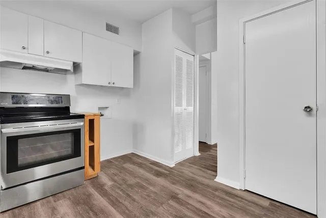 a kitchen with a stove and a refrigerator