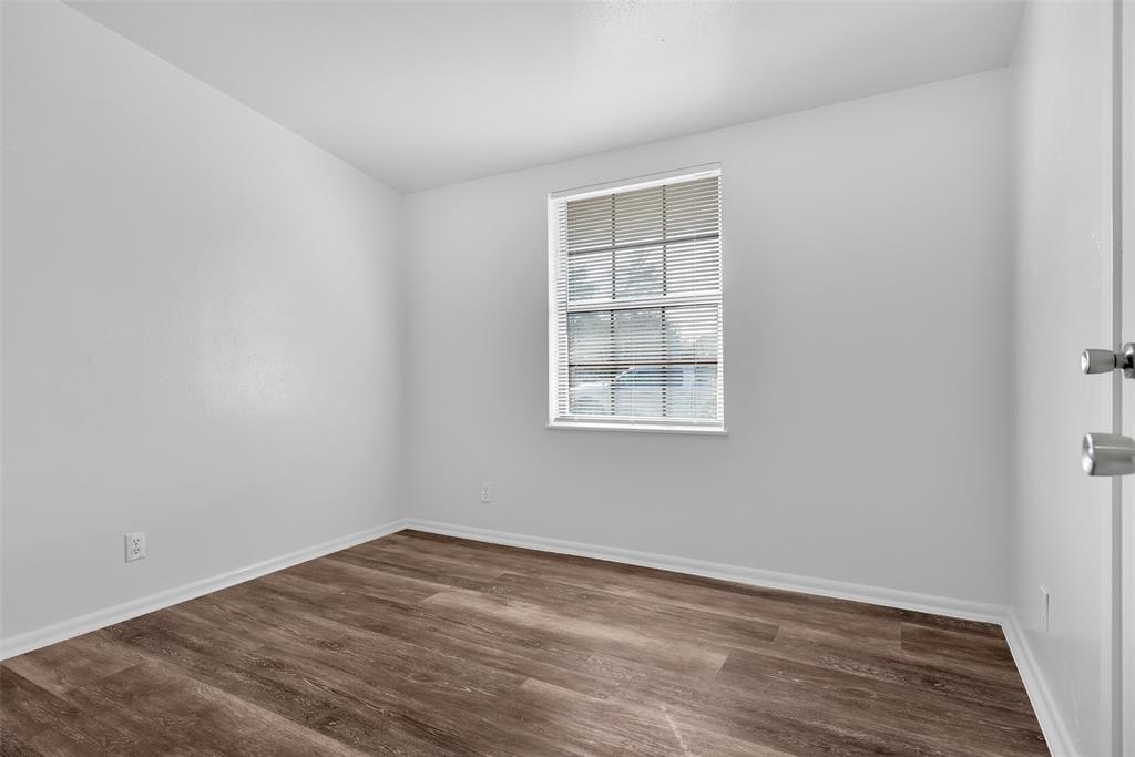 515 Forrest Lane Denison, TX 75021 - Photo 8 of 15 an empty room with wooden floor and windows