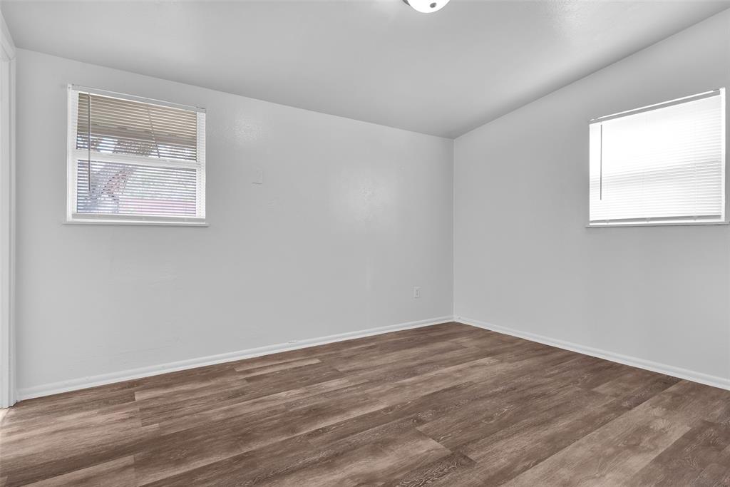 515 Forrest Lane Denison, TX 75021 - Photo 10 of 15 a view of an empty room with wooden floor and a window