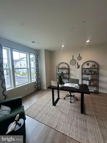 a living room with furniture a rug and a window