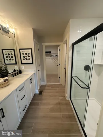 a bathroom with double vanity and a shower