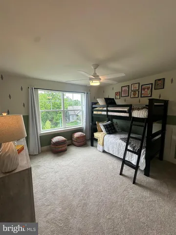 a bedroom with furniture and a large window