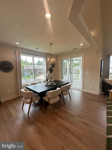 a living room with furniture a rug and a large window
