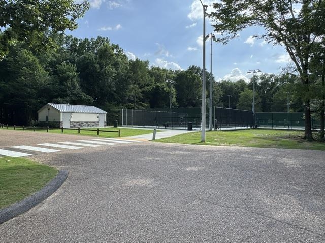 1897 Corbin Road Germantown, TN 38139 - Photo 21 of 22 Outdoor tennis courts with chain-link fencing, surrounded by mature trees