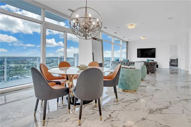 a dining room with furniture a chandelier and window