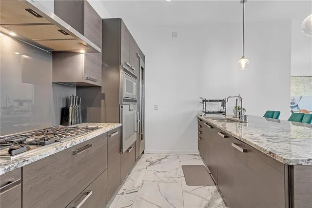 a kitchen with a sink stove and refrigerator
