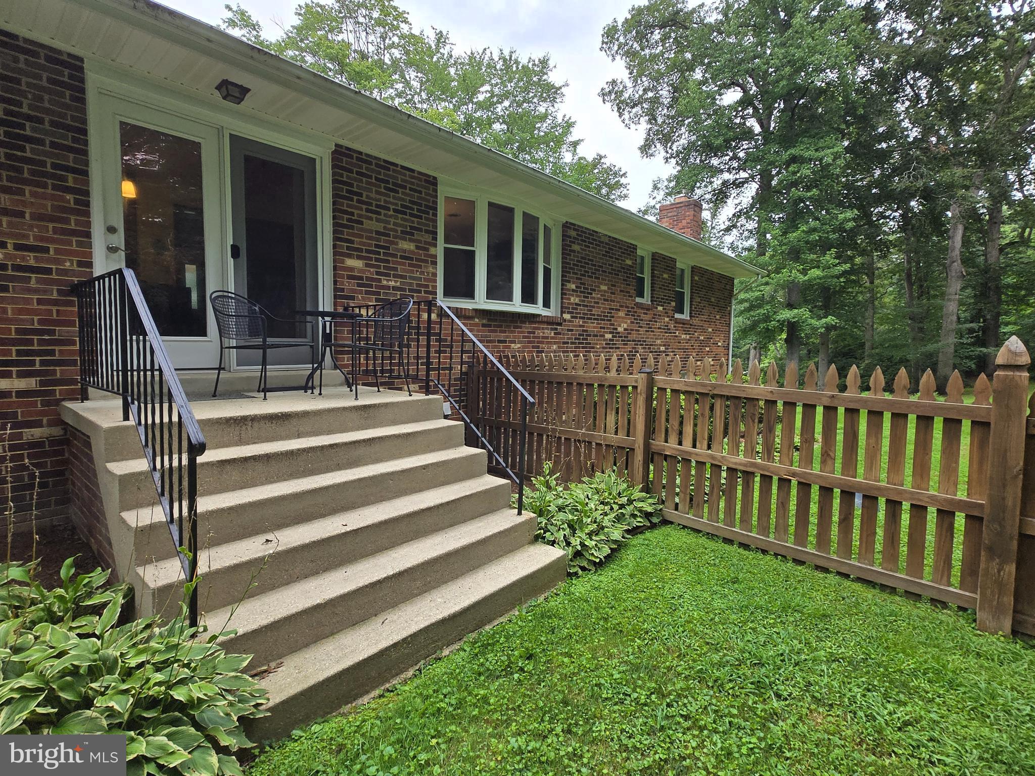 3908 Lakeside Court Dunkirk, MD 20754 - Photo 16 of 22 a view of a house with a small yard and wooden fence