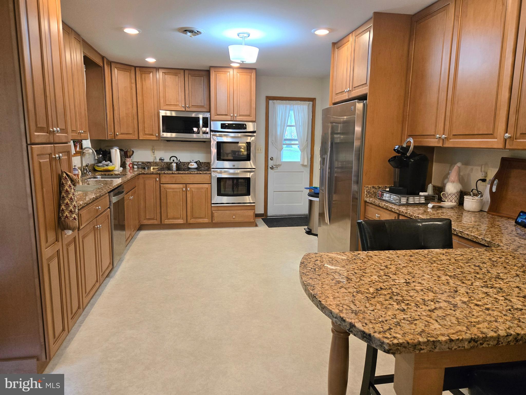 3908 Lakeside Court Dunkirk, MD 20754 - Photo 2 of 22 a kitchen with stainless steel appliances granite countertop a stove refrigerator sink and cabinets