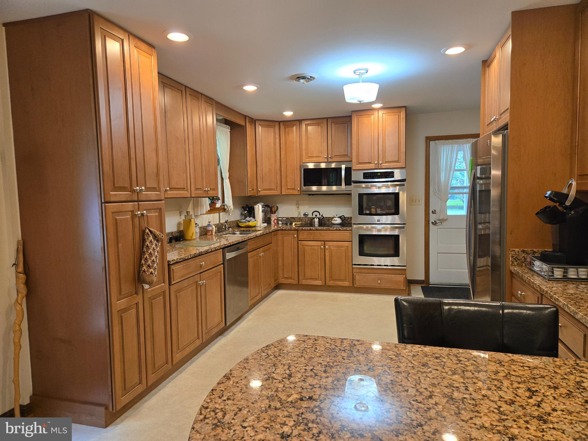 3908 Lakeside Court Dunkirk, MD 20754 - Photo 3 of 22 a kitchen with stainless steel appliances granite countertop a refrigerator a stove a sink and a microwave