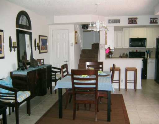 8231 B Thames Boulevard, Unit B Boca Raton, FL 33433 - Photo 6 of 10 a living room with furniture a flat screen tv and a fireplace