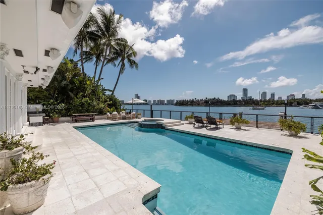 a view of a swimming pool with an outdoor seating and a yard