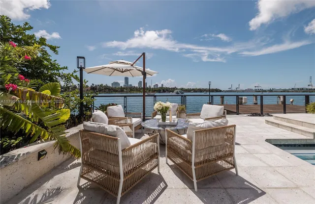 a view of a roof deck with couches and potted plants
