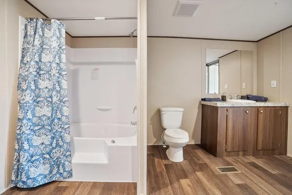 a bathroom with a toilet and a shower