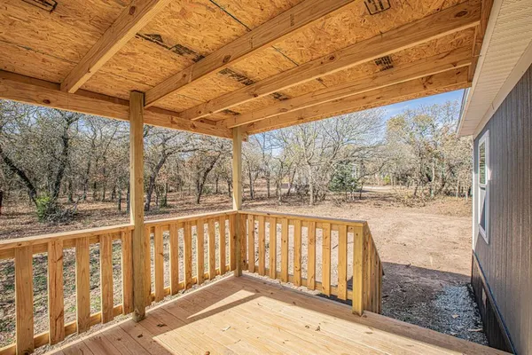 a view of balcony with wooden floor