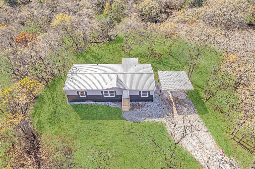 332 Huddleston Road Sunset, TX 76270 - Photo 28 of 28 an aerial view of a house with garden space and trees