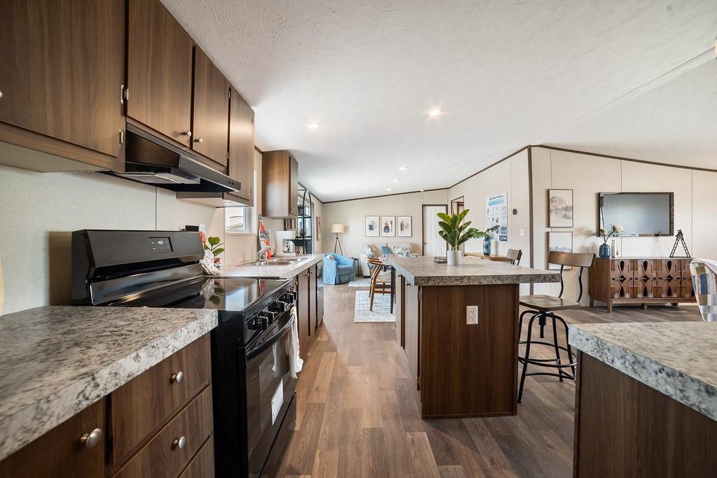 332 Huddleston Road Sunset, TX 76270 - Photo 10 of 28 a kitchen with stainless steel appliances granite countertop a sink stove and refrigerator