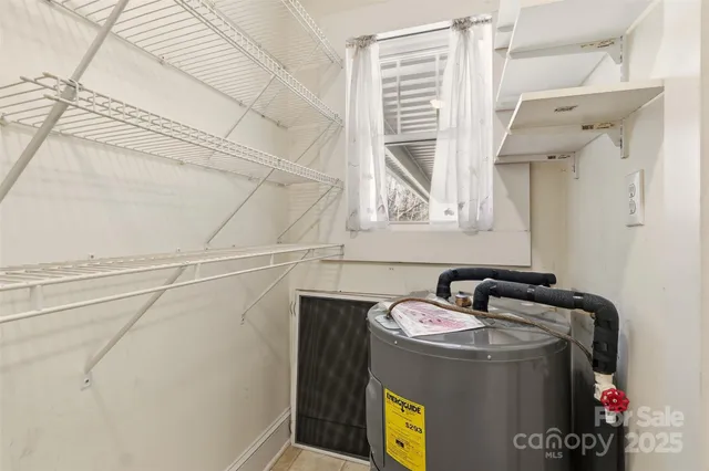 a view of a utility room with closet and windows