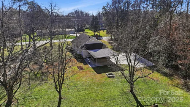 a swimming pool with outdoor seating and yard