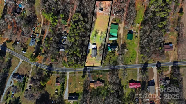 a aerial view of a house with a yard and mountain