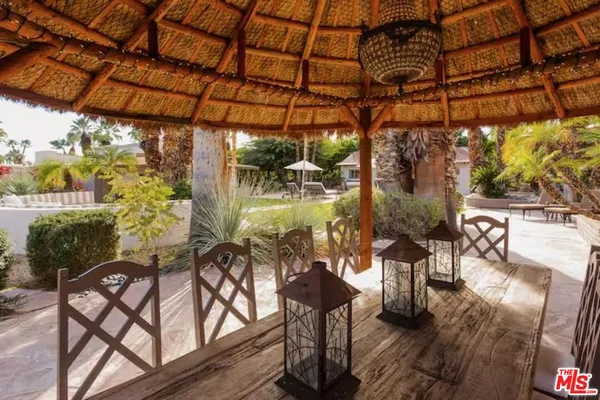 a view of a chairs and table in patio