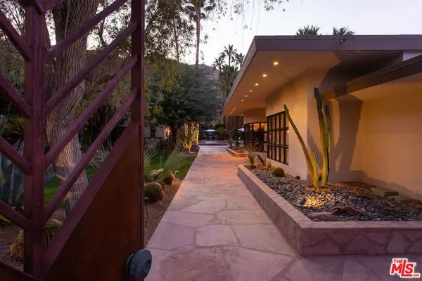 a pathway of a house with a yard