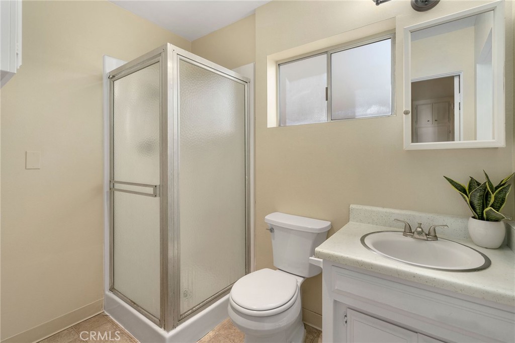 19 B Surfside Surfside, CA 90743 - Photo 20 of 35 a bathroom with a toilet a sink and mirror