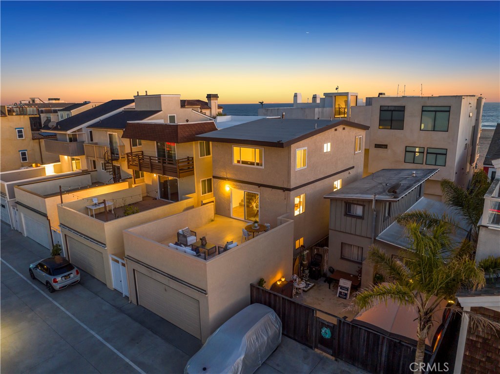 19 B Surfside Surfside, CA 90743 - Photo 29 of 35 a view of a patio with couches table and chairs under an umbrella