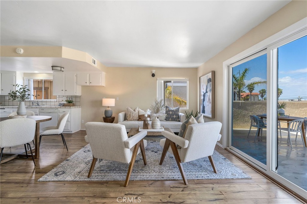 19 B Surfside Surfside, CA 90743 - Photo 3 of 35 a dining room with wooden floor a glass table and chairs