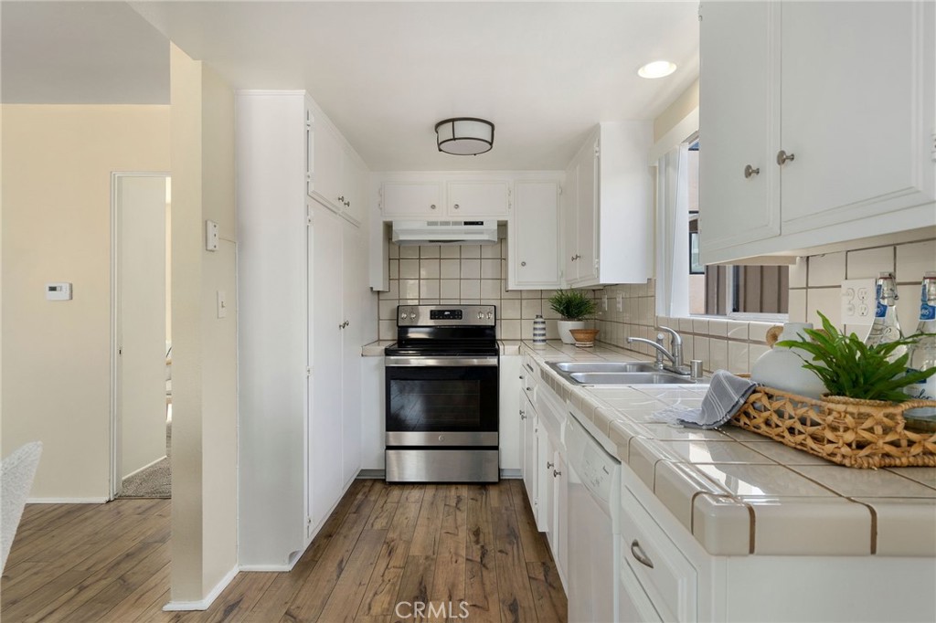 19 B Surfside Surfside, CA 90743 - Photo 7 of 35 a kitchen with a sink stove and cabinets
