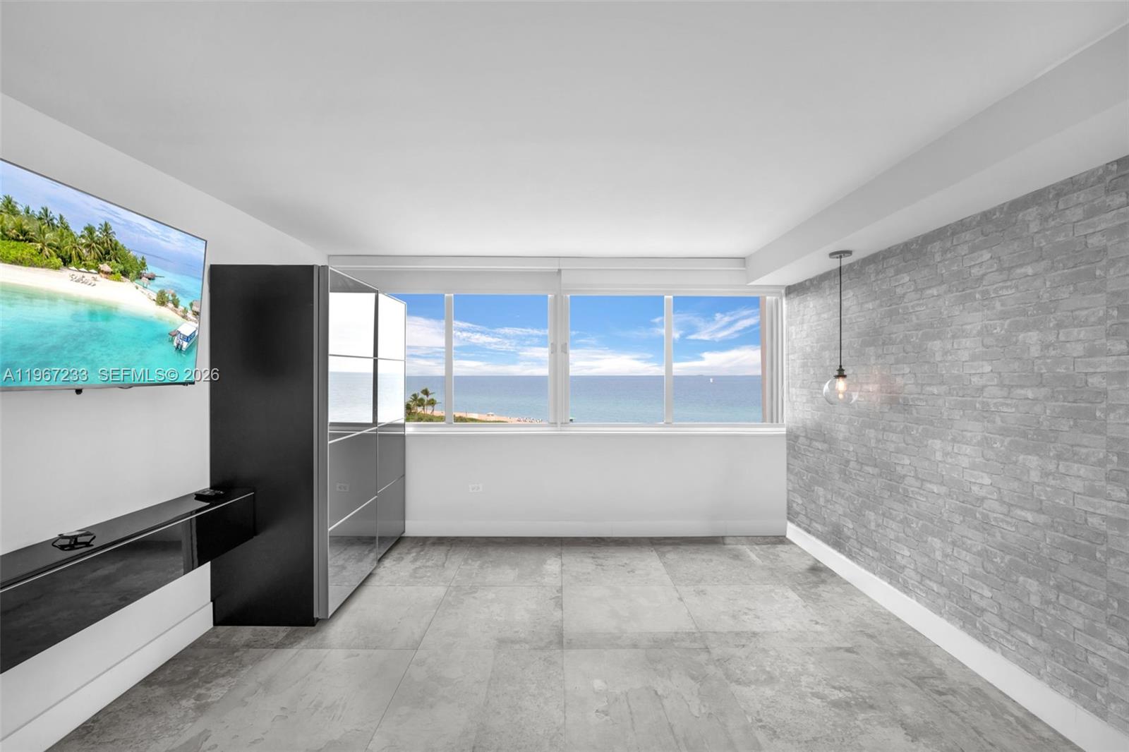 7135 Collins Avenue, Unit 736 Miami Beach, FL 33141 - Photo 16 of 27 a large white kitchen with a large window