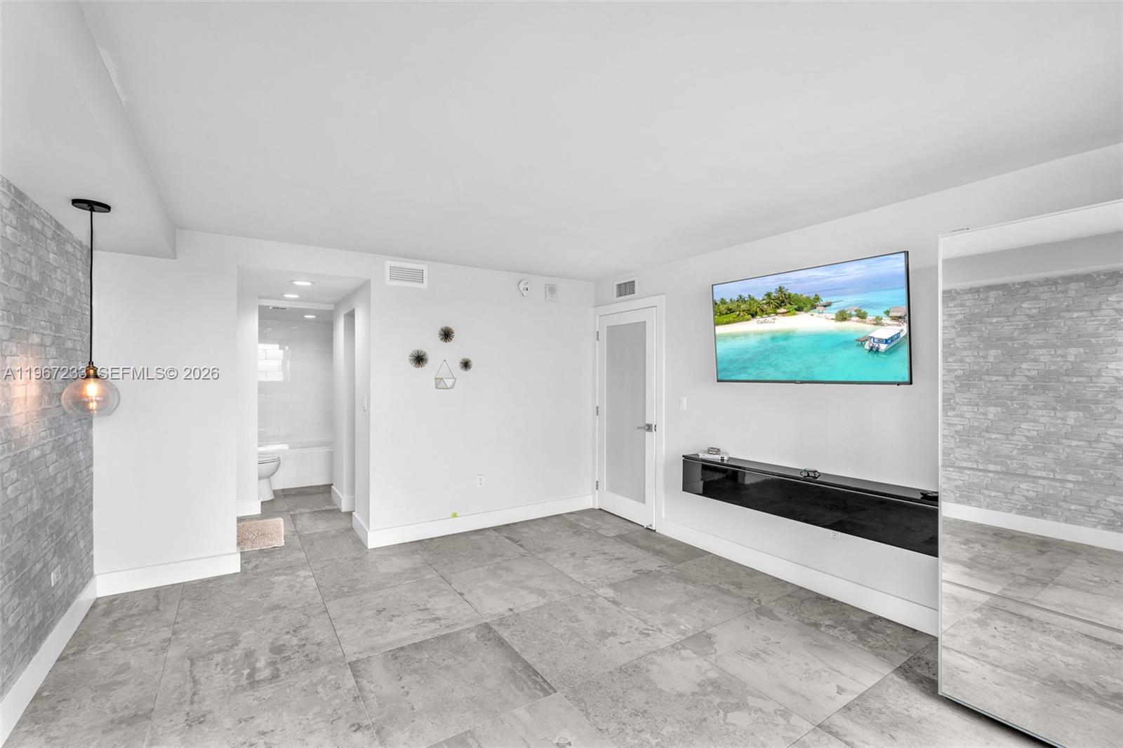 7135 Collins Avenue, Unit 736 Miami Beach, FL 33141 - Photo 17 of 27 a view of a big room with a flat screen tv