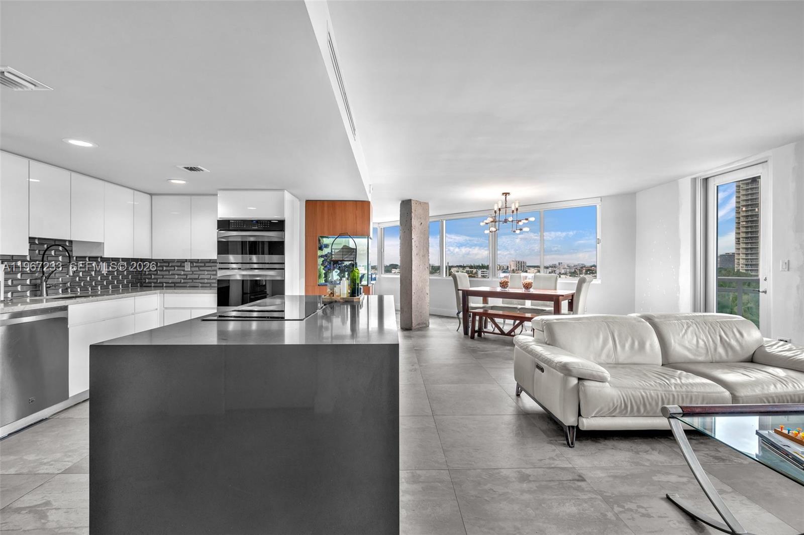 7135 Collins Avenue, Unit 736 Miami Beach, FL 33141 - Photo 2 of 27 a living room with furniture and kitchen view