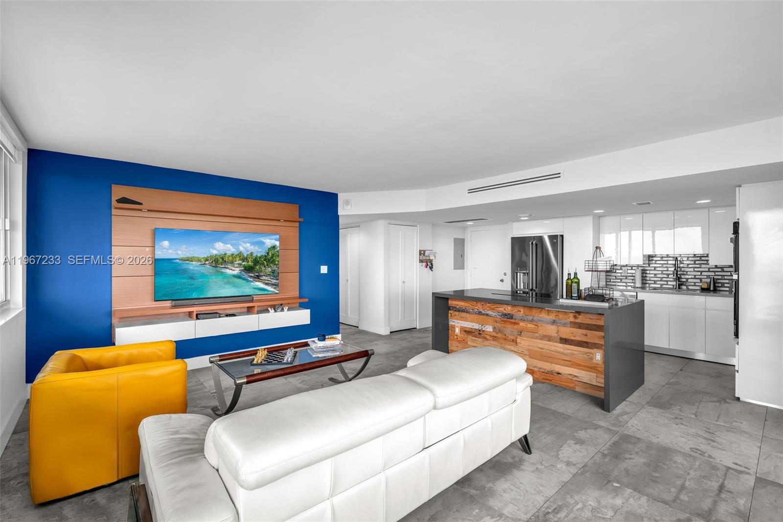 7135 Collins Avenue, Unit 736 Miami Beach, FL 33141 - Photo 5 of 27 a living room with furniture and a flat screen tv