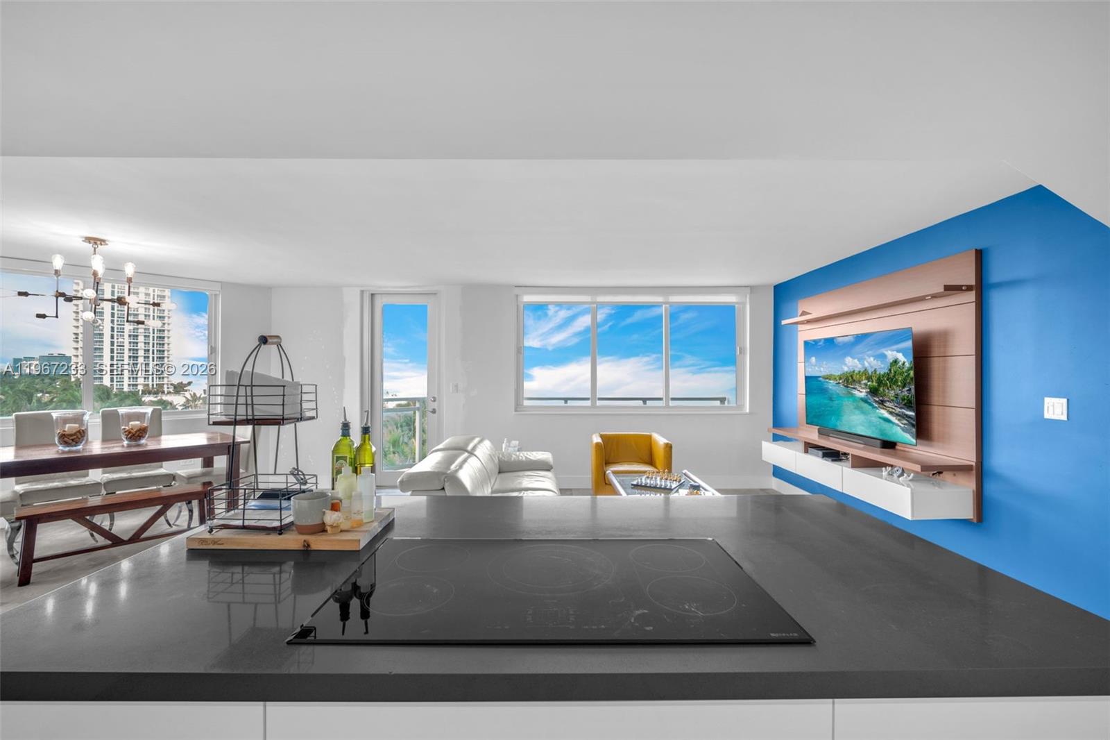 7135 Collins Avenue, Unit 736 Miami Beach, FL 33141 - Photo 8 of 27 a living room with furniture and a flat screen tv